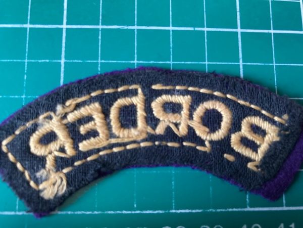 Reverse of BORDER Regiment shoulder title